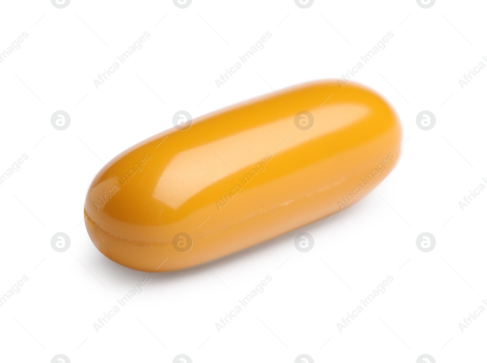 Photo of One orange pill on white background. Medicinal treatment