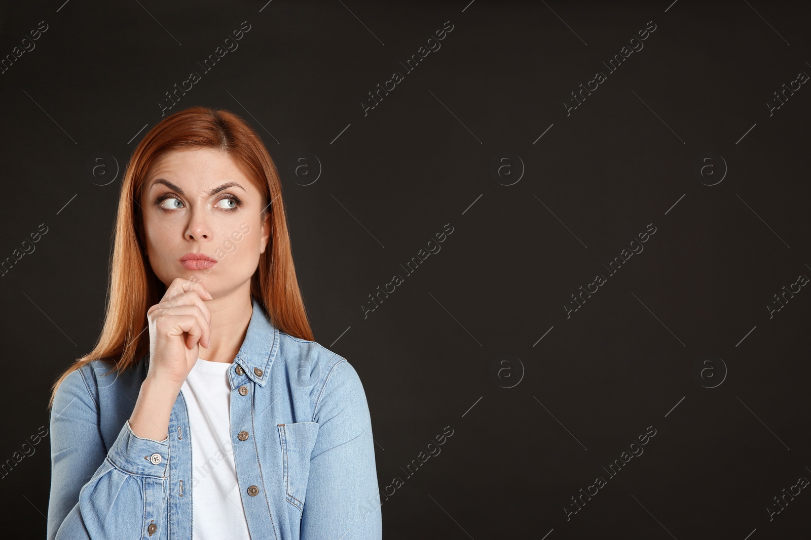 Photo of Pensive woman on black background, space for text. Thinking about answer to question