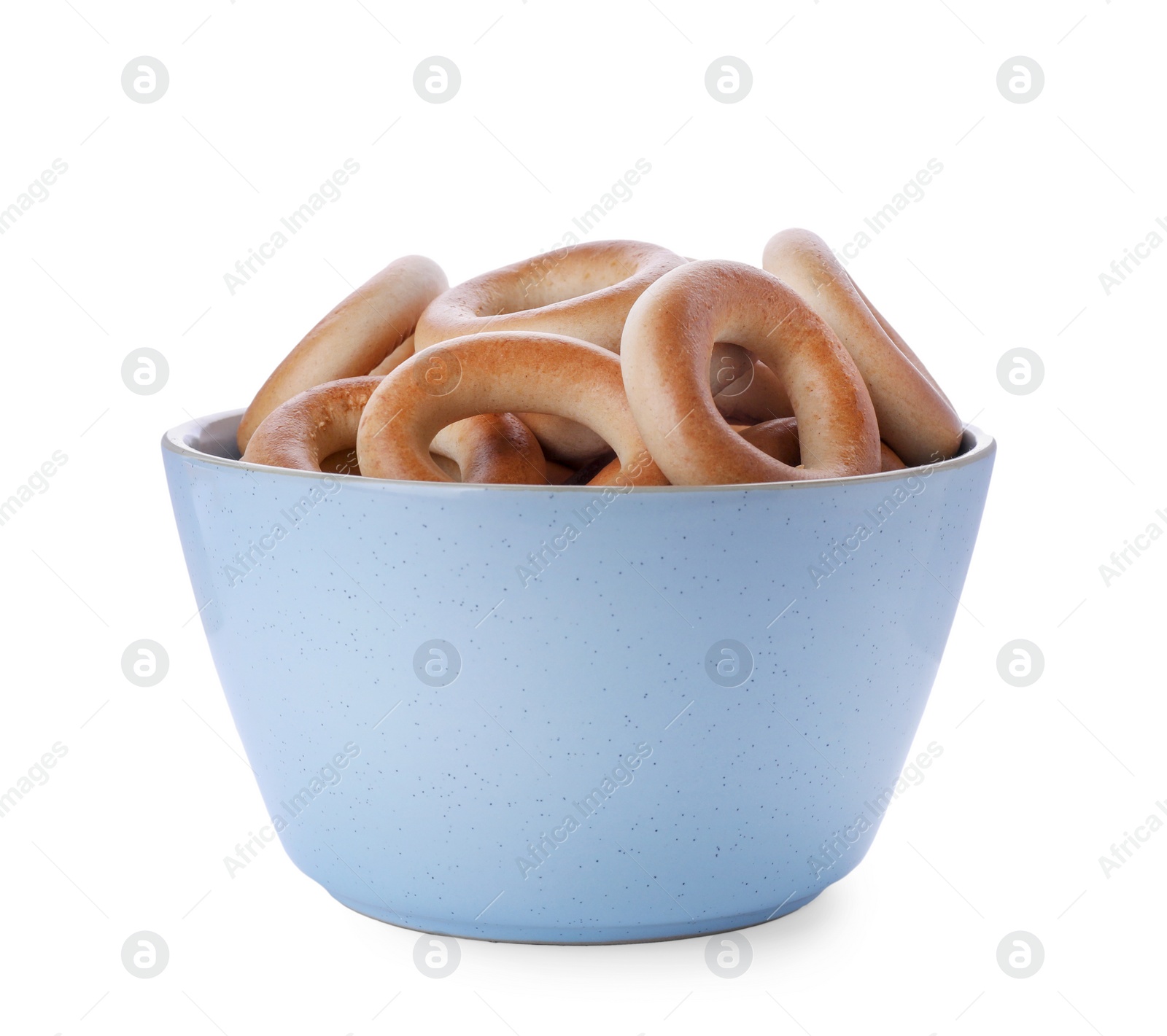 Photo of Bowl with tasty dry bagels (sushki) isolated on white