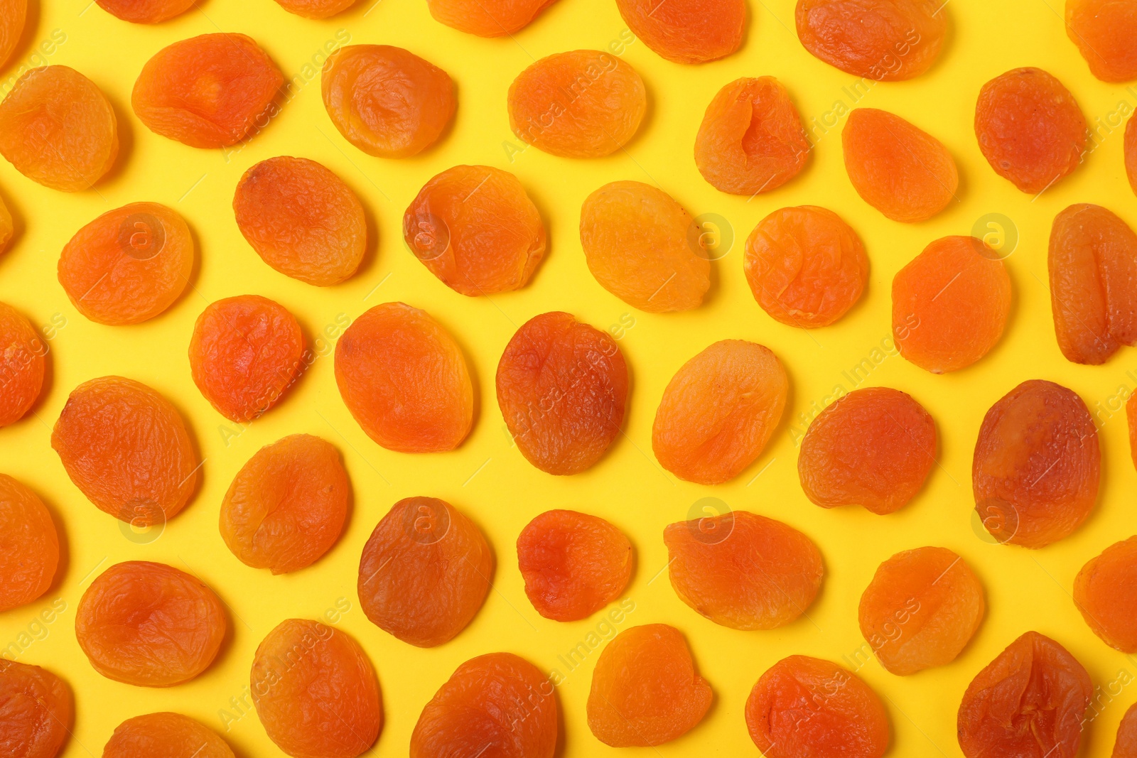 Photo of Flat lay composition with dried apricots on  color background. Healthy fruit