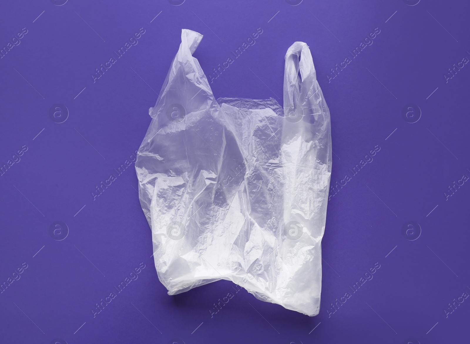 Photo of Clear disposable plastic bag on color background