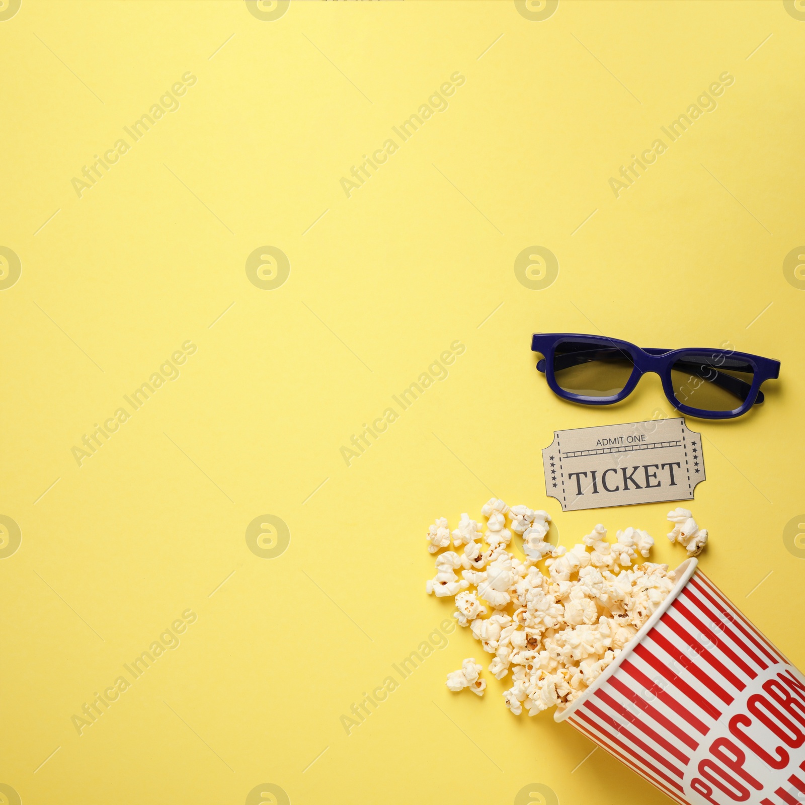 Photo of Flat lay composition with delicious popcorn on yellow background. Space for text