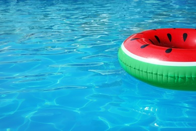 Photo of Inflatable ring floating in swimming pool on sunny day. Space for text