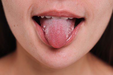 Closeup view of woman showing her tongue