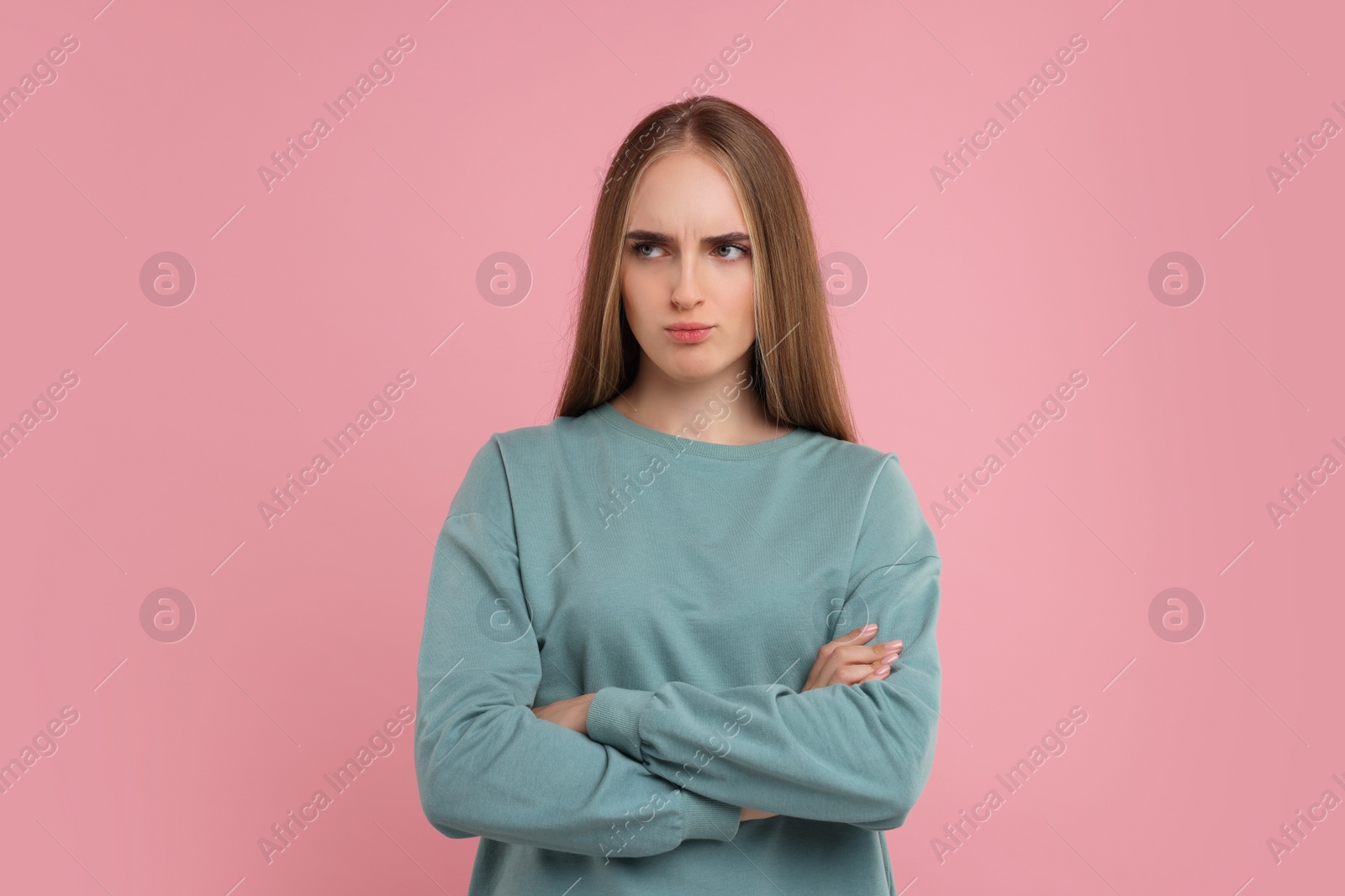 Photo of Portrait of resentful woman on pink background