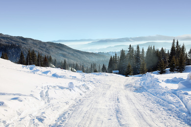 Photo of Empty road covered with snow on winter day