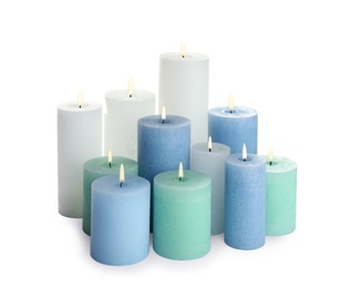 Photo of Set of different color candles on white background