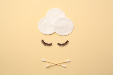 Photo of Flat lay composition with makeup removal tools and false eyelashes on yellow background