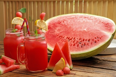 Photo of Delicious fresh watermelon drink on wooden table