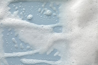 White washing foam on color background, top view