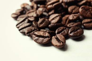 Roasted coffee beans on white background, closeup