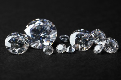 Many beautiful shiny diamonds on black background