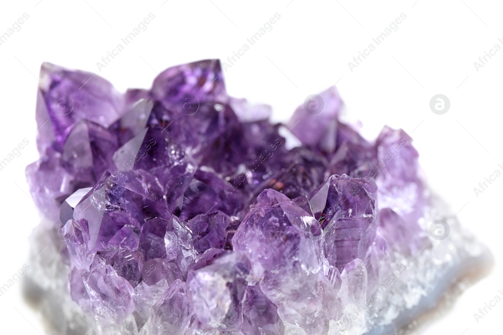 Photo of Beautiful purple amethyst gemstone on white background, closeup