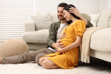 Photo of Pregnant woman with her husband at home