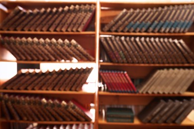 Blurred view of books on shelves in library