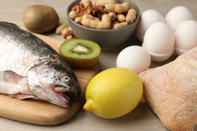 Photo of Allergenic food. Different fresh products on wooden table, closeup