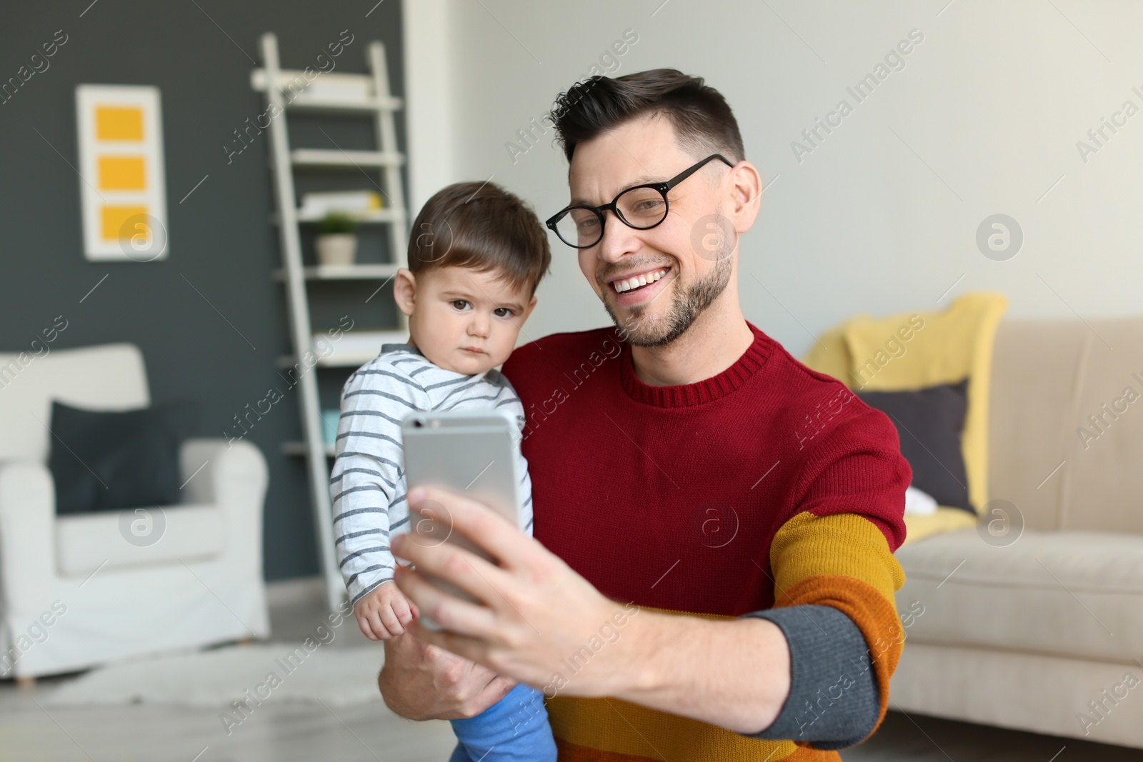 Photo of Dad and his son taking selfie at home