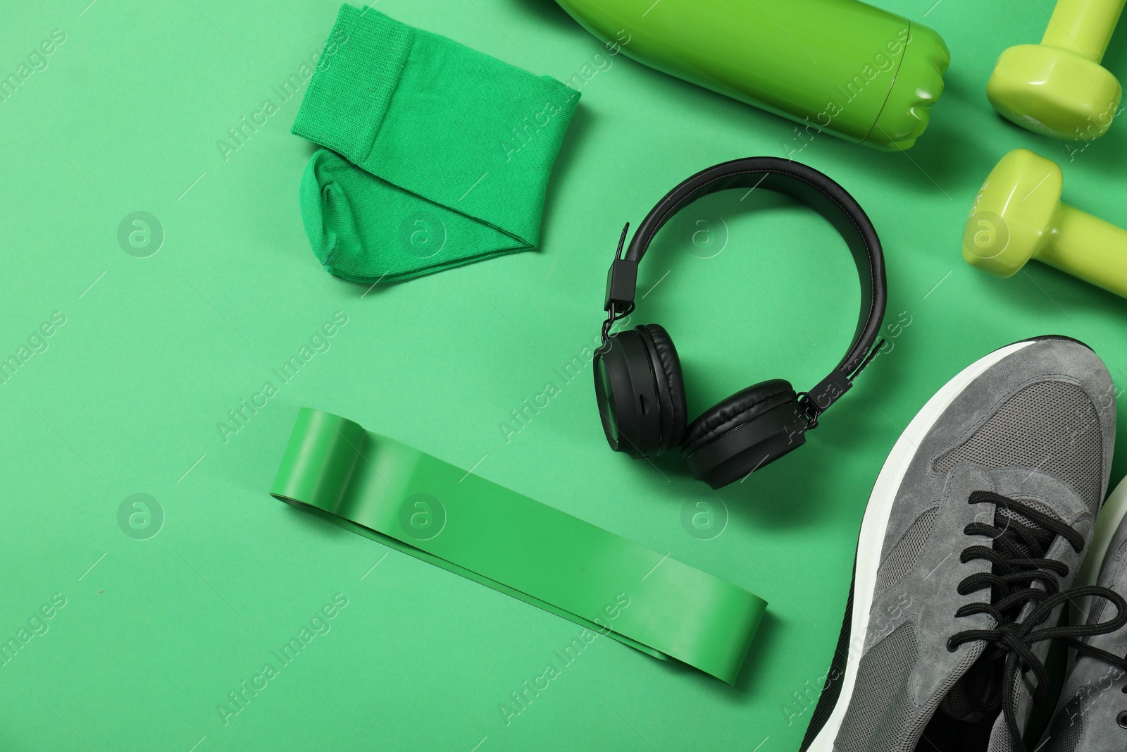 Photo of Different sports equipment on green background, flat lay