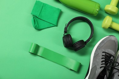 Photo of Different sports equipment on green background, flat lay