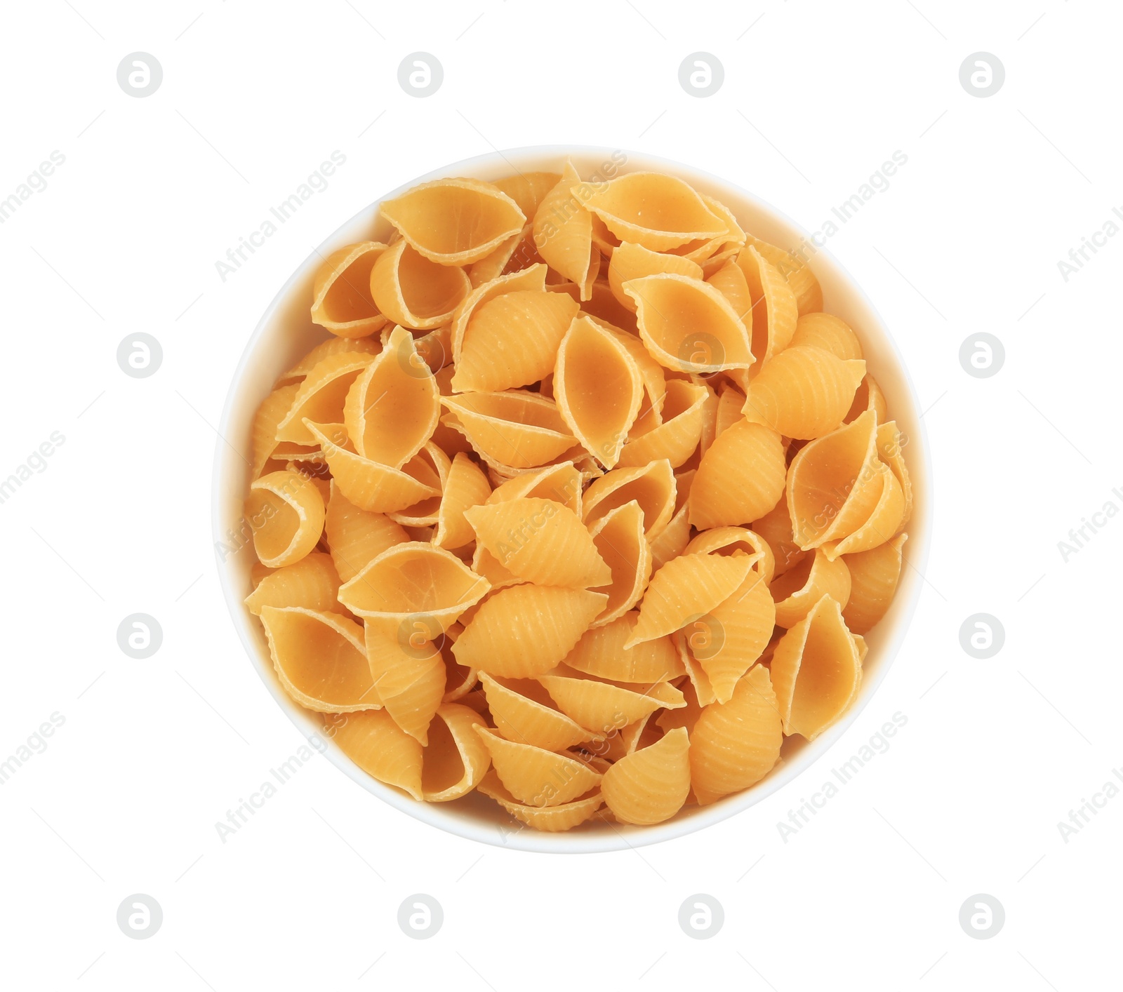 Photo of Raw conchiglie pasta in bowl isolated on white, top view