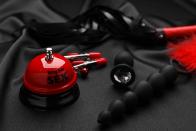 Photo of Sex toys and accessories on black fabric
