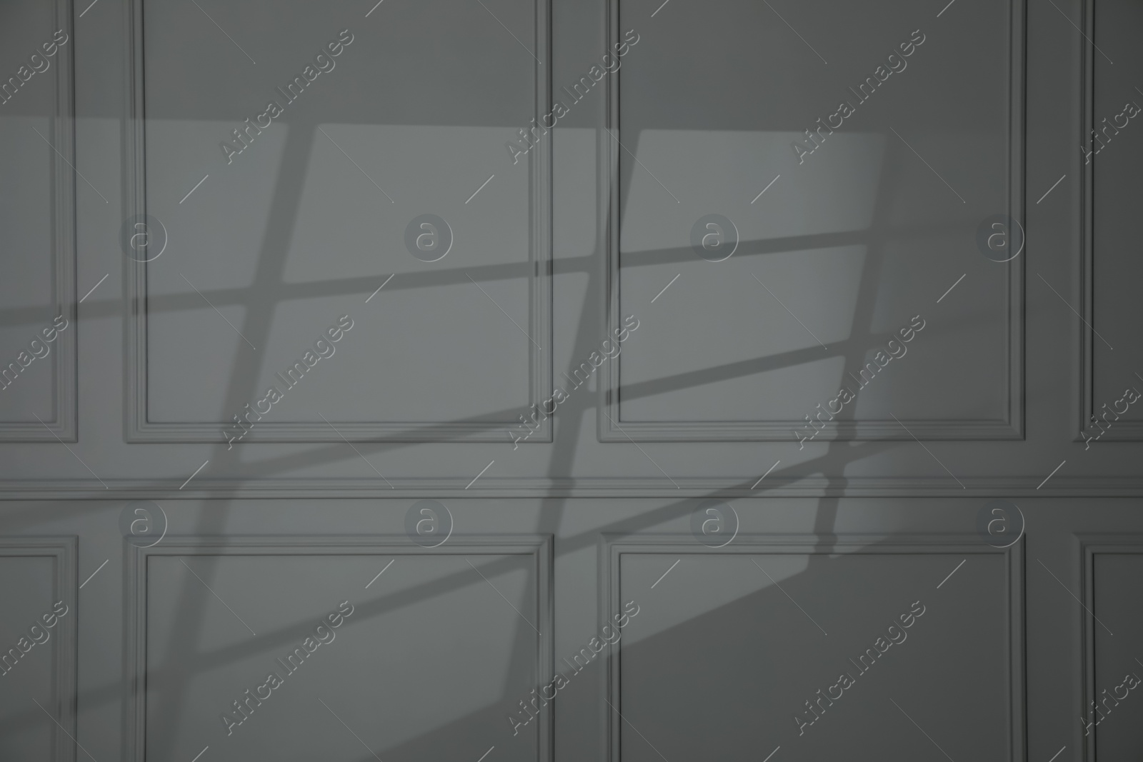 Photo of Shadow from window on dark grey wall indoors
