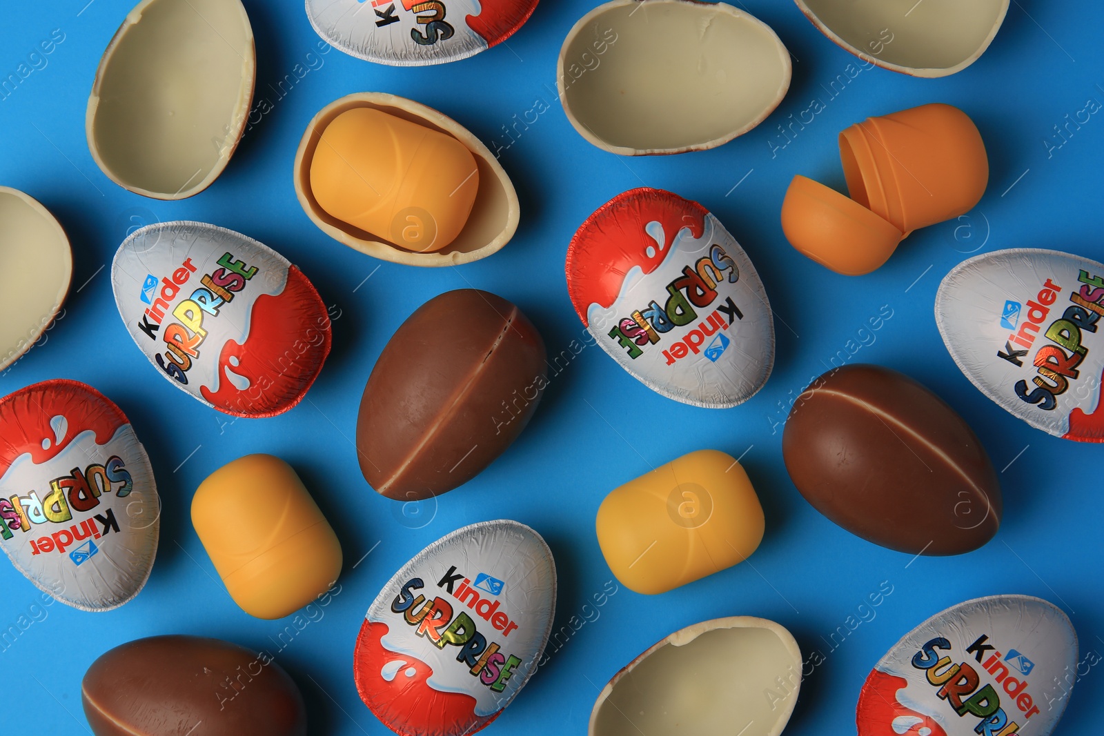 Photo of Sveti Vlas, Bulgaria - June 29, 2023: Kinder Surprise Eggs and plastic capsules on light blue background, flat lay