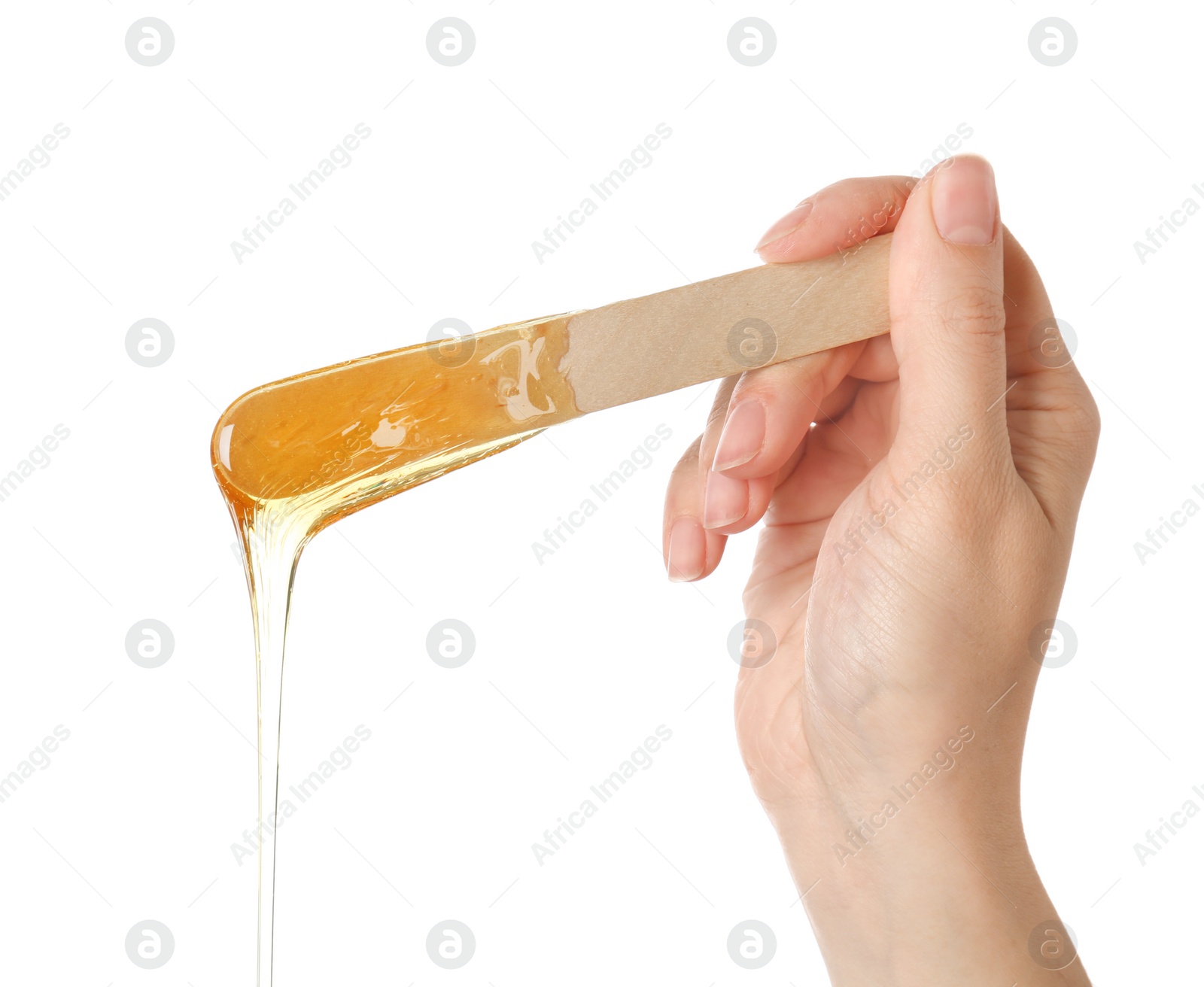 Photo of Woman holding wooden stick with sugaring paste on white background, closeup