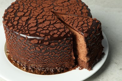 Photo of Delicious chocolate truffle cake on grey table, closeup