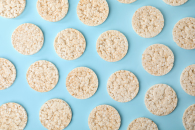 Photo of Puffed rice cakes on light blue background, flat lay