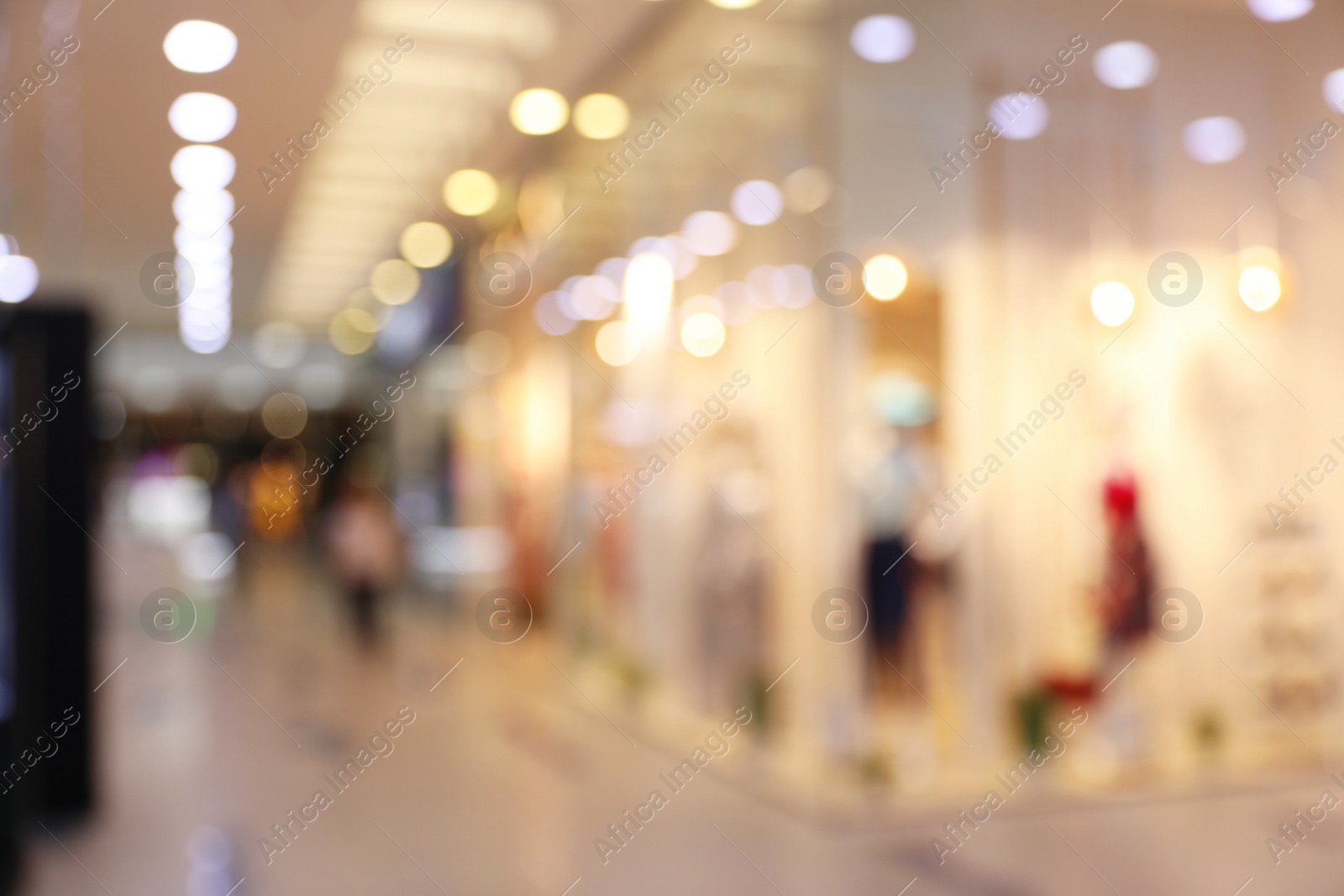 Photo of Blurred view of modern shopping mall interior. Bokeh effect