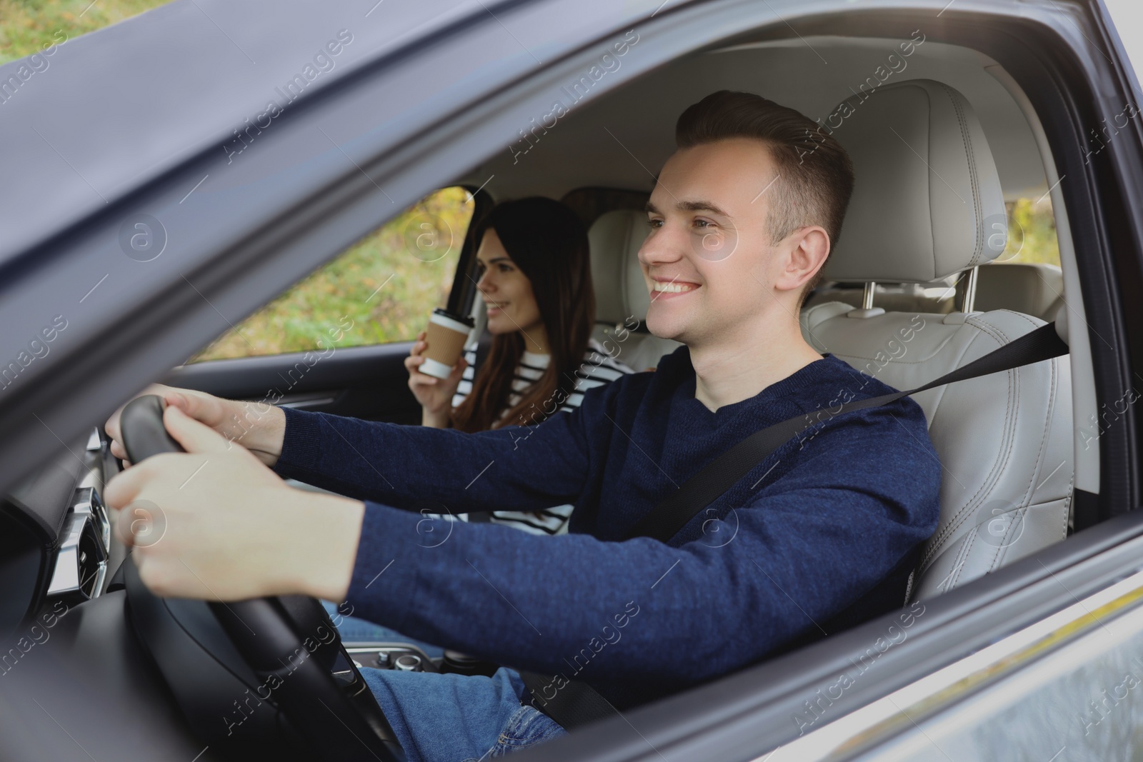 Photo of Happy young couple travelling together by car