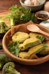 Tasty vegan cutlets and ingredients on wooden table