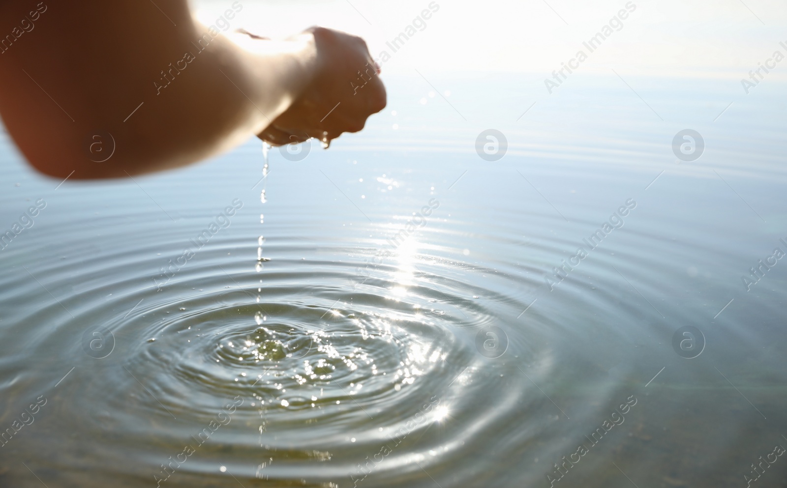 Photo of Woman taking pure water from river, closeup. Nature healing power