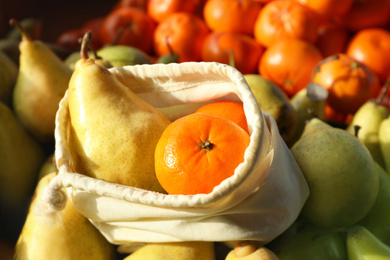 Cotton eco bag with fruits on pears, closeup. Life without plastic