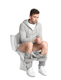 Photo of Emotional man sitting on toilet bowl, white background