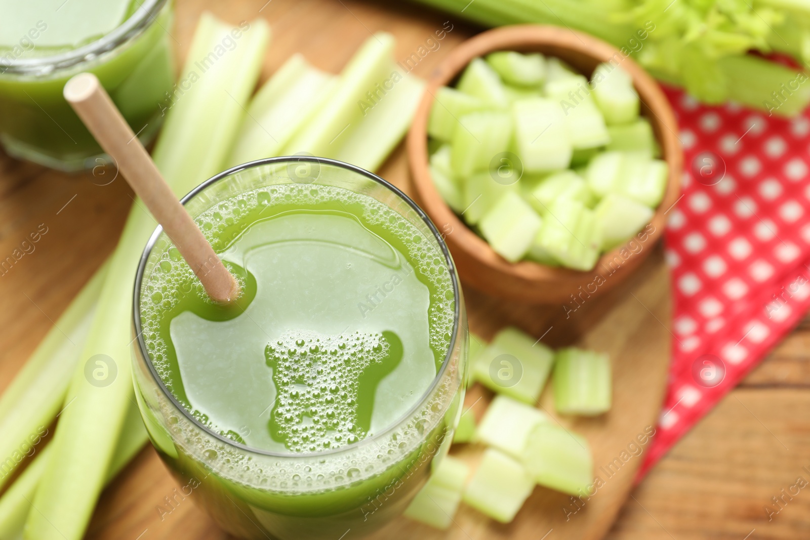Photo of Glass of delicious celery juice and vegetables on wooden table, above view