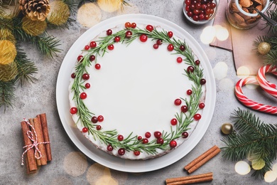 Image of Flat lay composition with traditional Christmas cake on light grey table. Bokeh effect