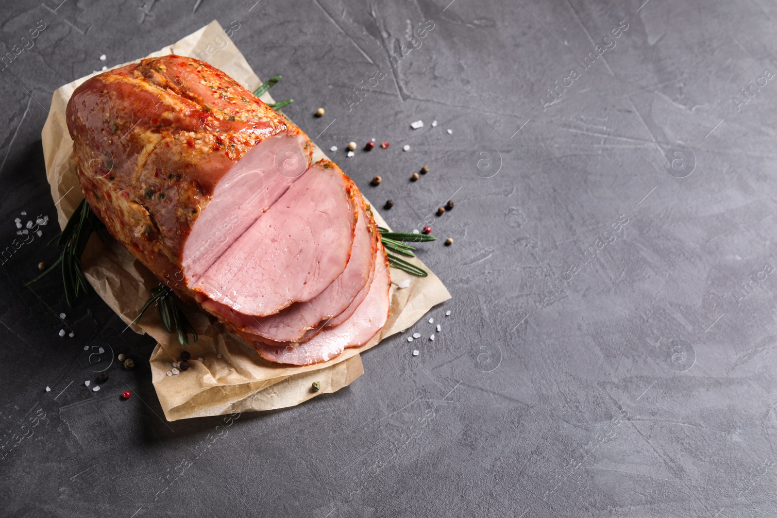 Photo of Delicious ham on grey table, top view with space for text. Christmas dinner