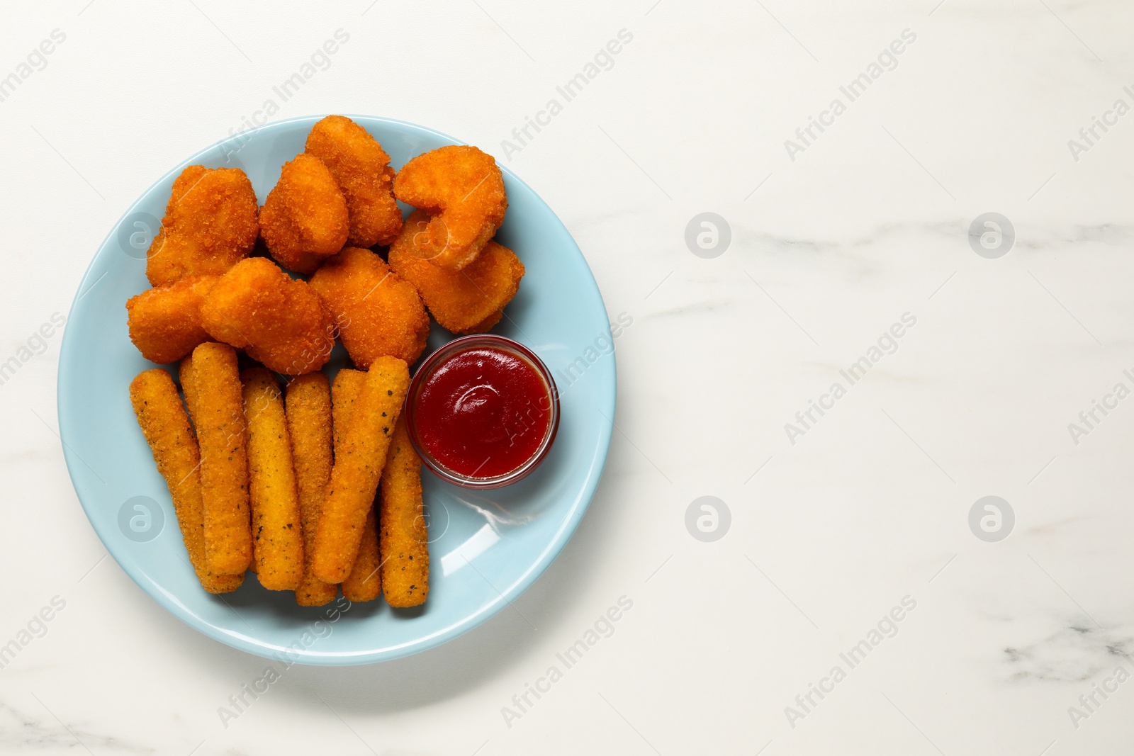 Photo of Plate with tasty ketchup, chicken nuggets and cheese sticks on marble table, top view. Space for text