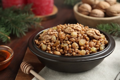 Photo of Fresh tasty traditional kutia in bowl on table, closeup