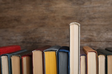 Photo of Stack of hardcover books on wooden background