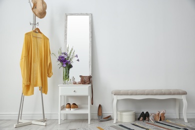 Photo of Stylish hallway interior with mirror and rack