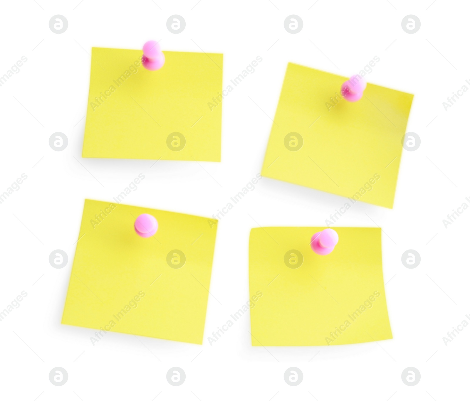 Photo of Blank pale yellow notes with pink pins on white background, top view. Space for text