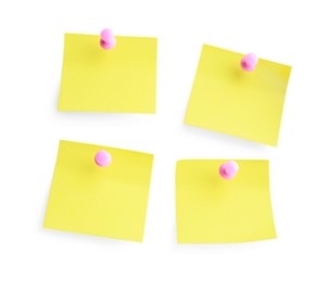 Blank pale yellow notes with pink pins on white background, top view. Space for text