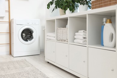 Laundry room interior with washing machine and furniture