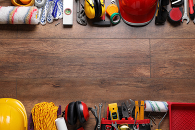 Photo of Flat lay composition with different construction tools and space for text on wooden background