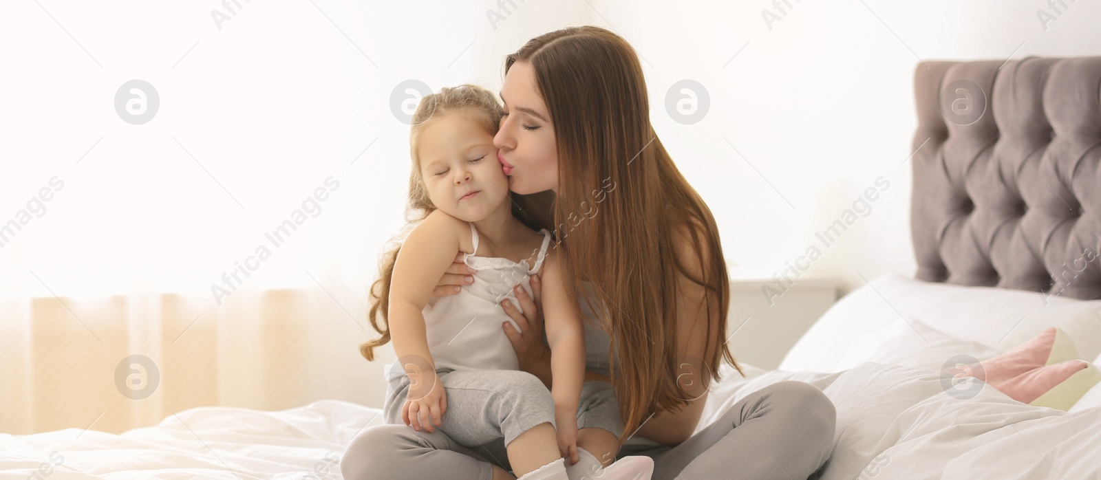 Image of Happy mother with little daughter in bedroom. Banner design