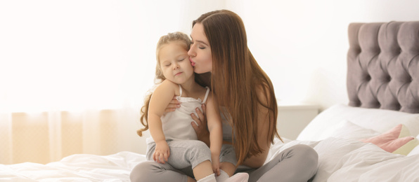 Image of Happy mother with little daughter in bedroom. Banner design