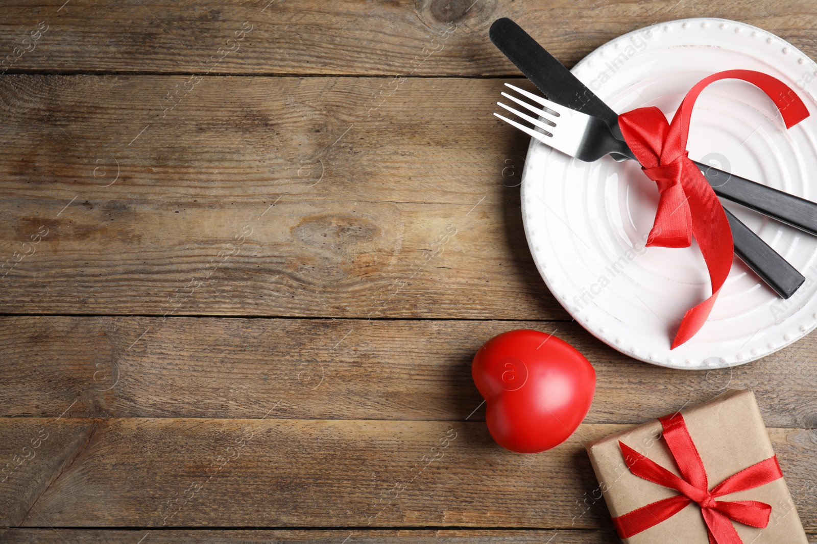 Photo of Beautiful place setting on wooden table, flat lay with space for text. Valentine's day romantic dinner